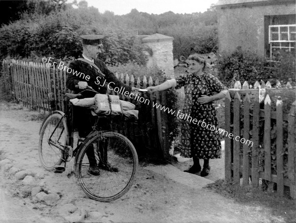 POSTMAN DELIVERING LETTER TO LADY AT COTTAGE GATE